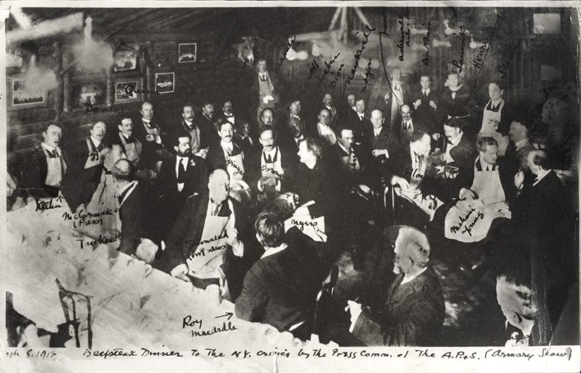 Artists and members of the press wearing aprons at a 1913 Beefsteak dinner connected to the Armory Show